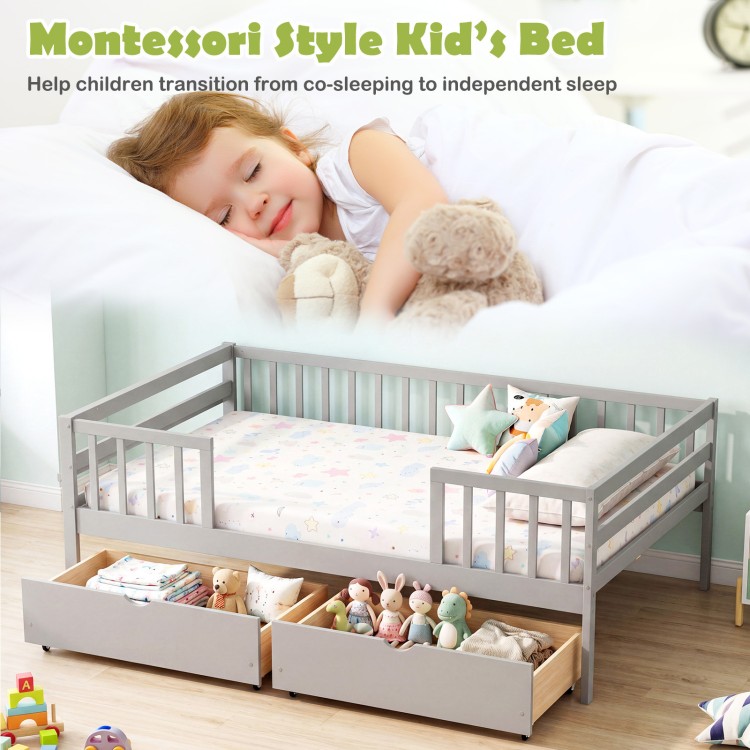 Full-size gray daybed with fence and two pull-out drawers, designed for children's storage and safety.