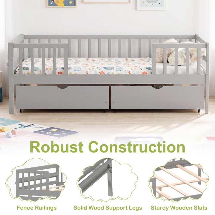 Full size gray daybed with fence, two pull-out drawers, and sturdy wooden slats for children's storage and safety.