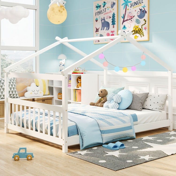 Montessori floor bed in white featuring a house design, colorful decorations, and a child-friendly height for playtime.