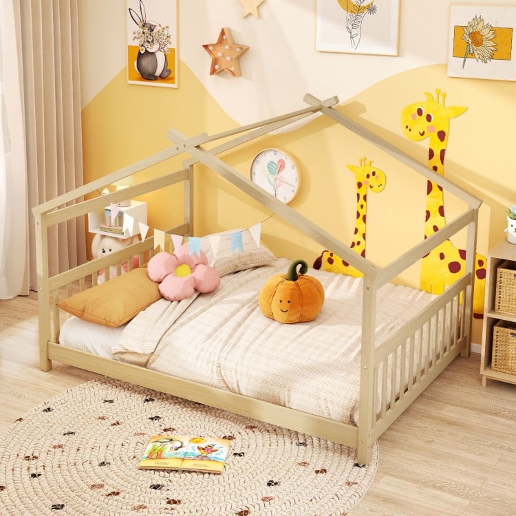Montessori floor bed in white featuring a house design, playful ornaments, and solid wood legs for children's.