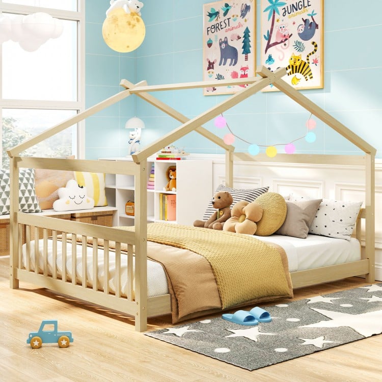Full size house bed in white with decorative lights and a cozy layout, perfect for imaginative children's play and.