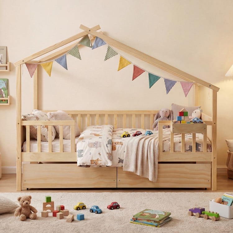 House-shaped full-size bed with fence rails and storage drawers, made of solid wood for kids' imaginative play.