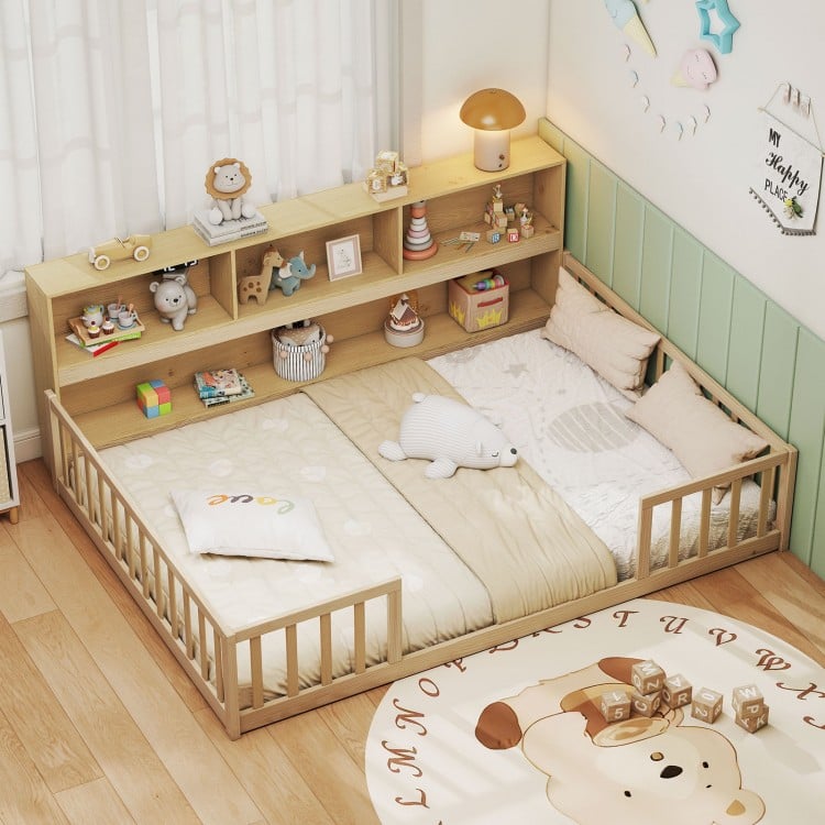 Montessori floor bed with integrated bookcase in natural wood, promoting independence and organized play for kids.