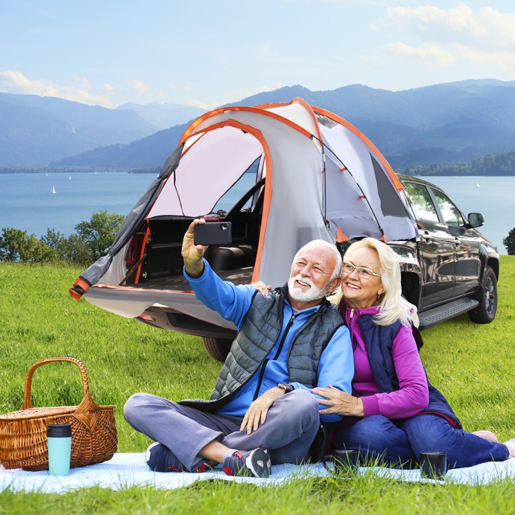 Couple enjoying a selfie in front of the 2 Person Portable Pickup Tent, ideal for camping and outdoor adventures.