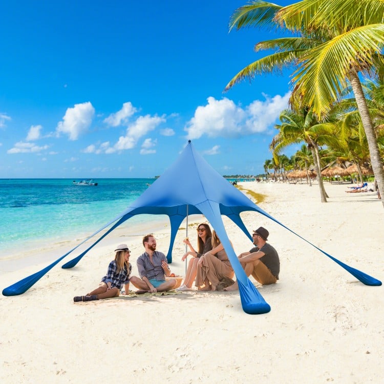 Blue 20 x 20 feet beach canopy tent with UPF50+ sun protection, set up for 2-3 people on the sandy beach.