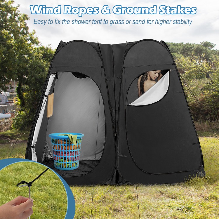 Oversized pop-up shower tent in black with window, storage pocket, and ground stakes for stability during use.