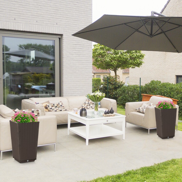Two brown wicker flower pots with drainage holes, perfect for outdoor decoration and plant cultivation on a patio.