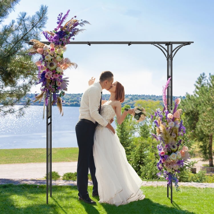 Metal garden arch with floral decorations, perfect for supporting climbing plants and enhancing garden entryways.