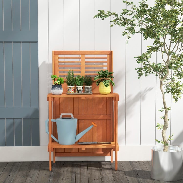 Folding garden potting bench with teak oil finish, showcasing a shutter-shaped design for enhanced ventilation and.