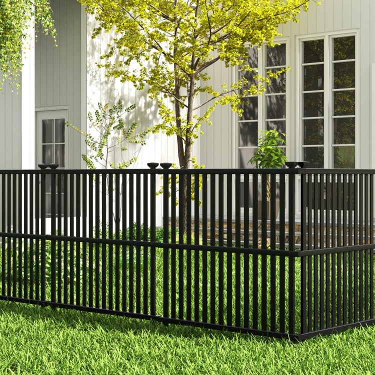 Black air conditioner fence panel with slatted surface and metal ground stakes for outdoor stability and air.