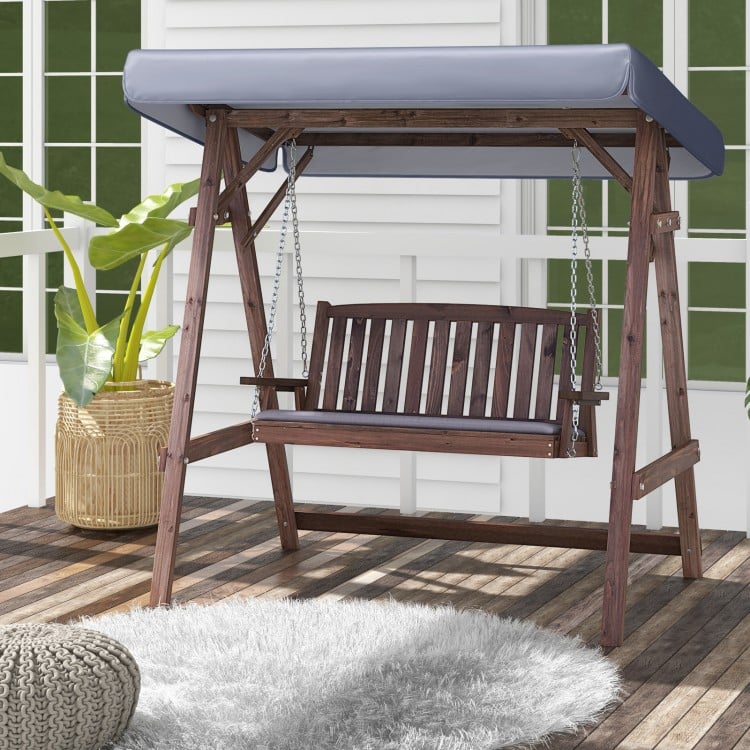 2-person porch swing with fir wood stand and adjustable tilt canopy, perfect for outdoor relaxation and sun protection.