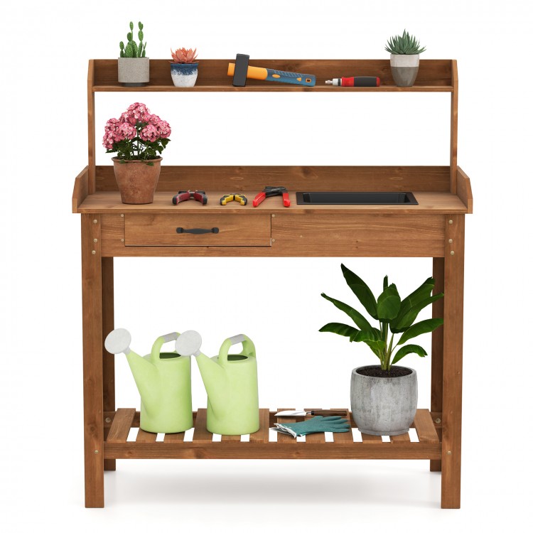 Outdoor wooden garden table work station with sink, storage drawer, and shelves for organized gardening tasks.