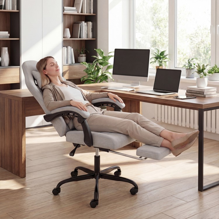 Ergonomic gray gaming chair with headrest, reclining backrest, and retractable footrest for optimal comfort in office.