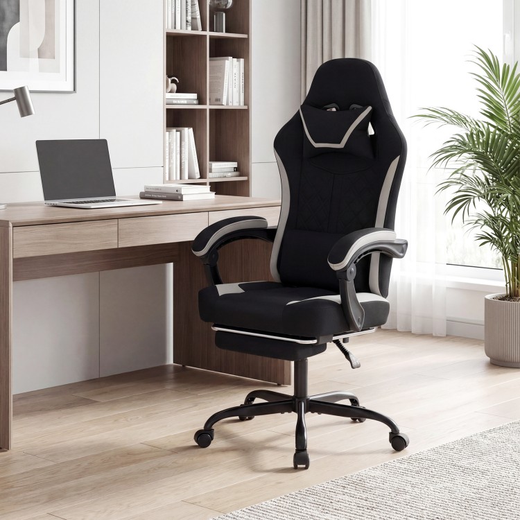 Height adjustable black gaming chair with headrest, footrest, and ergonomic design for optimal comfort during gaming.