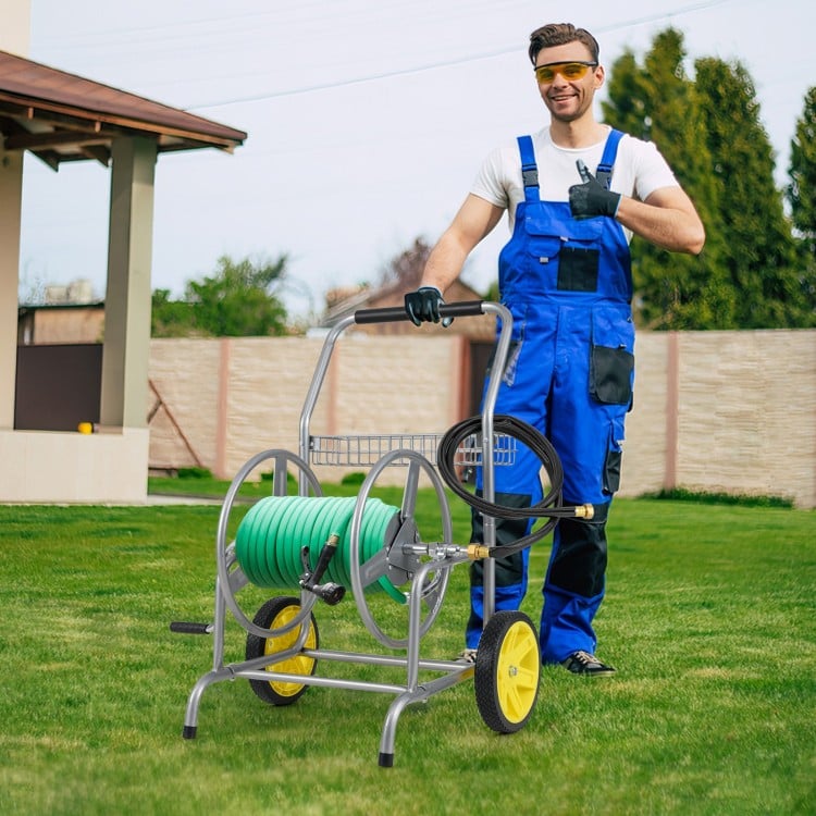 Garden hose reel cart with two wheels, storage basket, and foam-padded handrail for easy maneuvering in the yard.