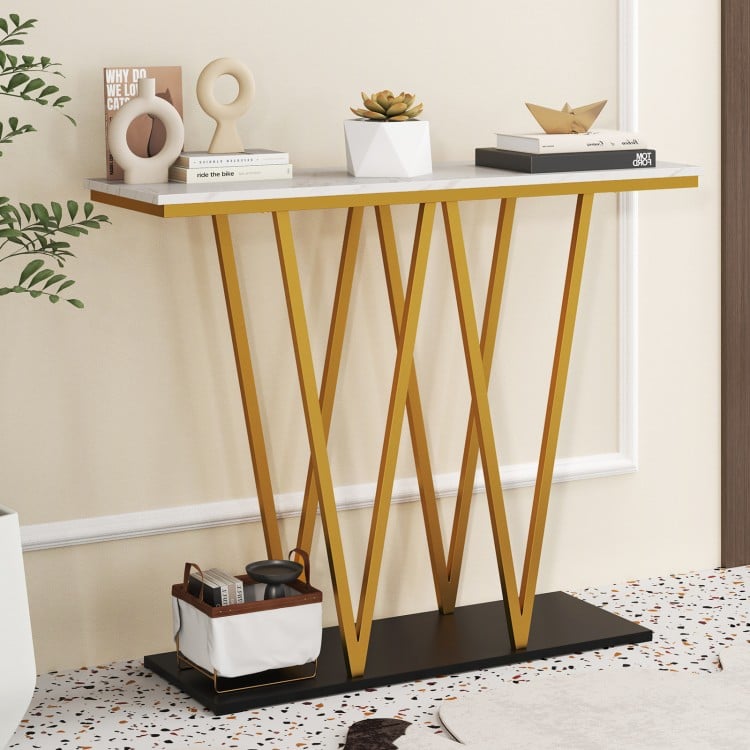 Gold entryway table with faux marble top and metal frame, perfect for narrow spaces and displaying decorations.
