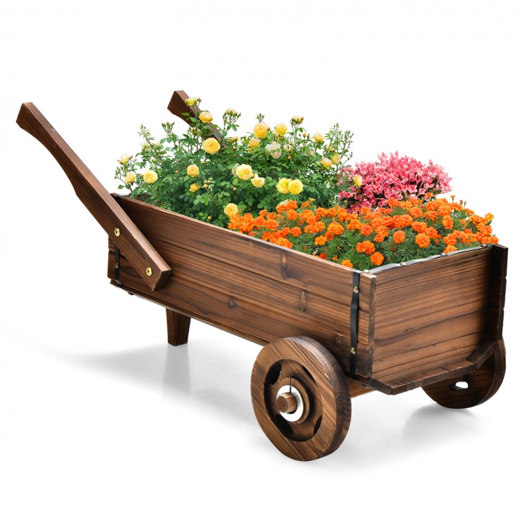 Wooden wagon planter box in rustic brown with flowers, featuring wheels and drainage hole for versatile indoor/outdoor.