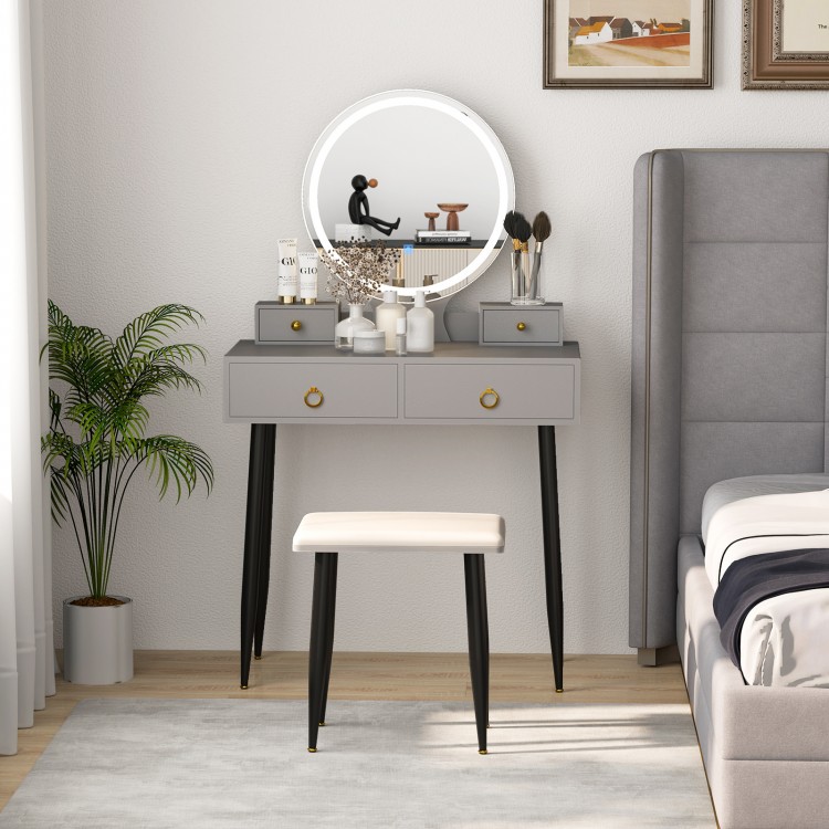 Gray vanity table with a round mirror and padded stool, showcasing four drawers and stylish adjustable lighting.