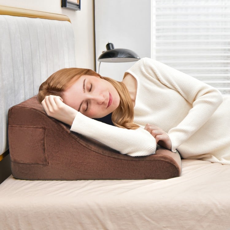 Brown bed wedge pillow with tablet stand, side pockets, and soft cover, ideal for neck and back support.