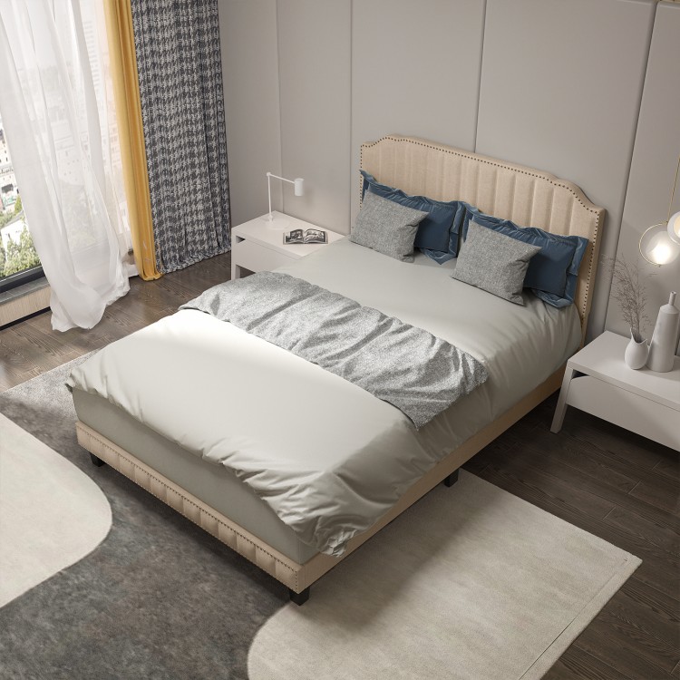 Full view of a beige heavy-duty upholstered bed frame with rivet headboard, featuring comfortable bedding for a modern.