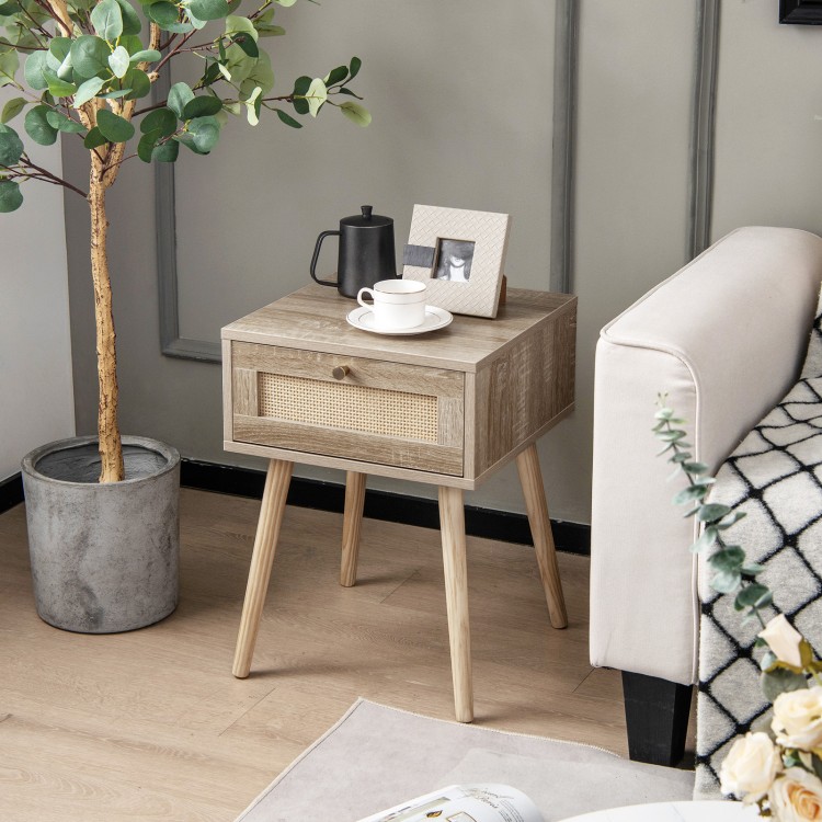 Modern rattan nightstand with drawer and solid wood legs, featuring a natural finish for bedroom or living room decor.