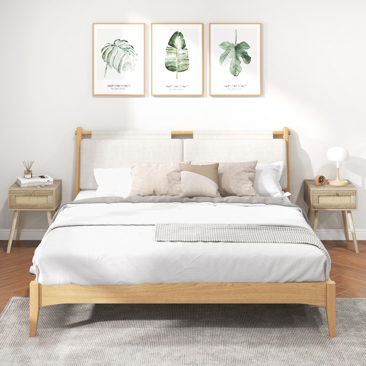 Natural rattan nightstand with drawer and solid wood legs, perfect for bedroom or living room decor.