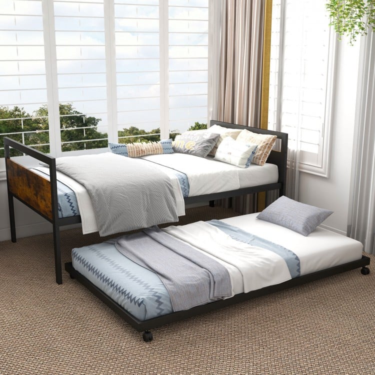 Twin metal daybed with trundle, featuring lockable wheels and sturdy support, ideal for living room or guest room use.