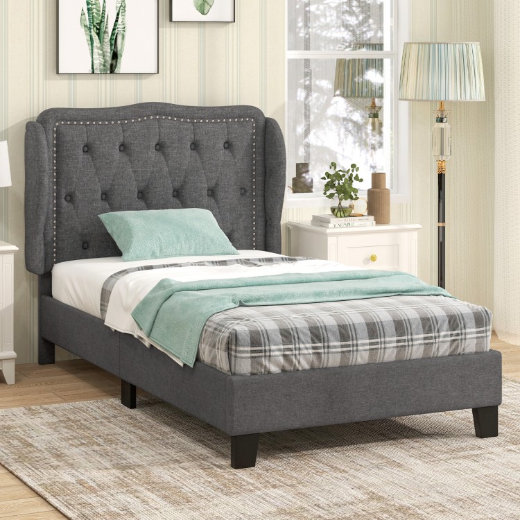 Gray twin size bed frame with upholstered wingback headboard and cozy linen fabric, designed for stylish storage.