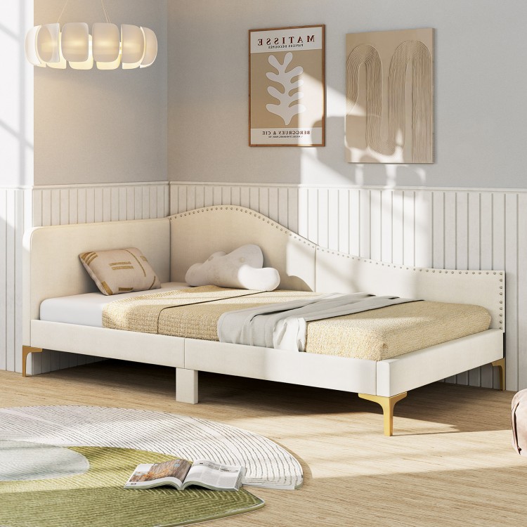 Upholstered twin size daybed with metal legs, rivet design, and wood slats, perfect for versatile living spaces.