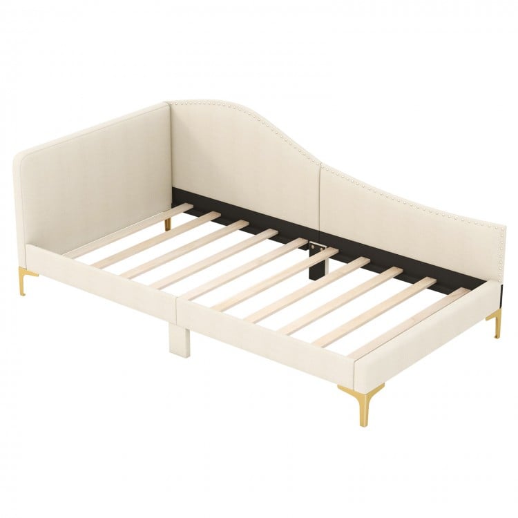 Upholstered twin size daybed with metal legs, wood slats, and rivet design, ideal for versatile use as a sofa or bed.