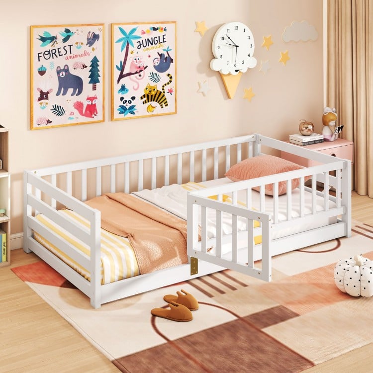 Twin size floor bed with high fence and door, crafted from sturdy pine wood, ideal for children's safety and play.