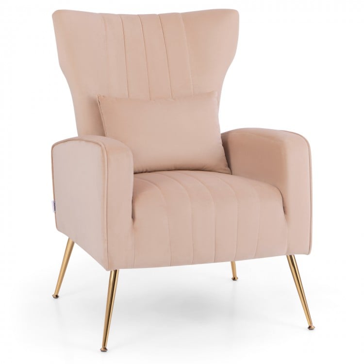 Velvet upholstered wingback chair in pink with lumbar pillow and golden metal legs, perfect for living rooms and.