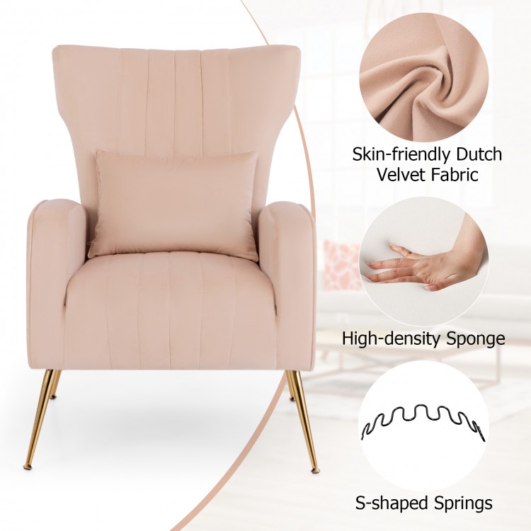 Close-up of pink velvet upholstery and lumbar pillow on wingback chair, featuring golden metal legs for elegance and.