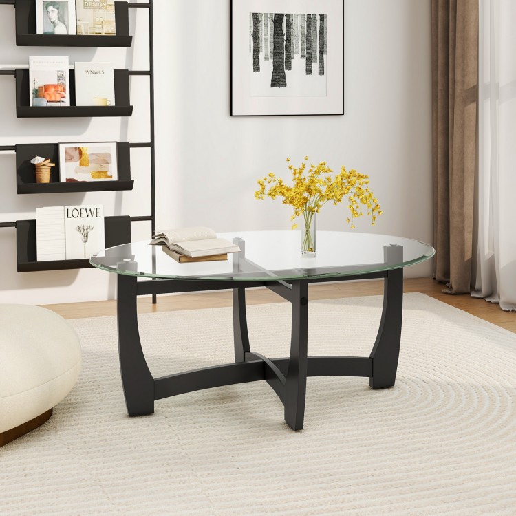 Oval coffee table showcasing a sleek tempered glass top and black rubber wood legs, perfect for a stylish living room.