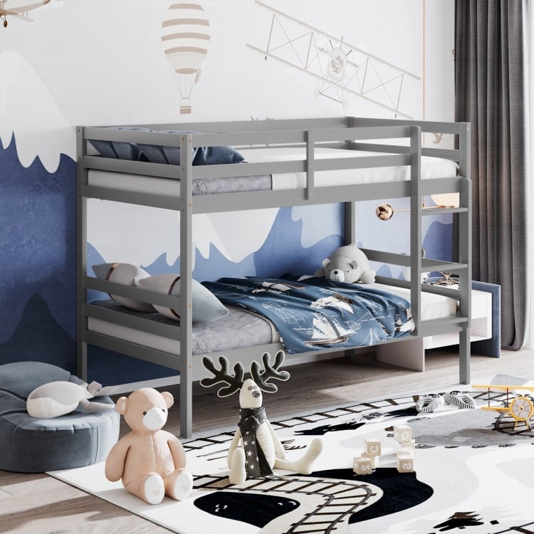 Twin size gray wooden bunk bed with ladder and safety rail, perfect for compact spaces and family use.