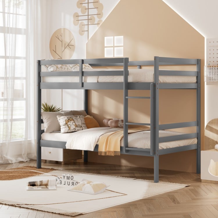Twin size gray wooden bunk beds with ladder and safety rail, ideal for space-saving in compact rooms.
