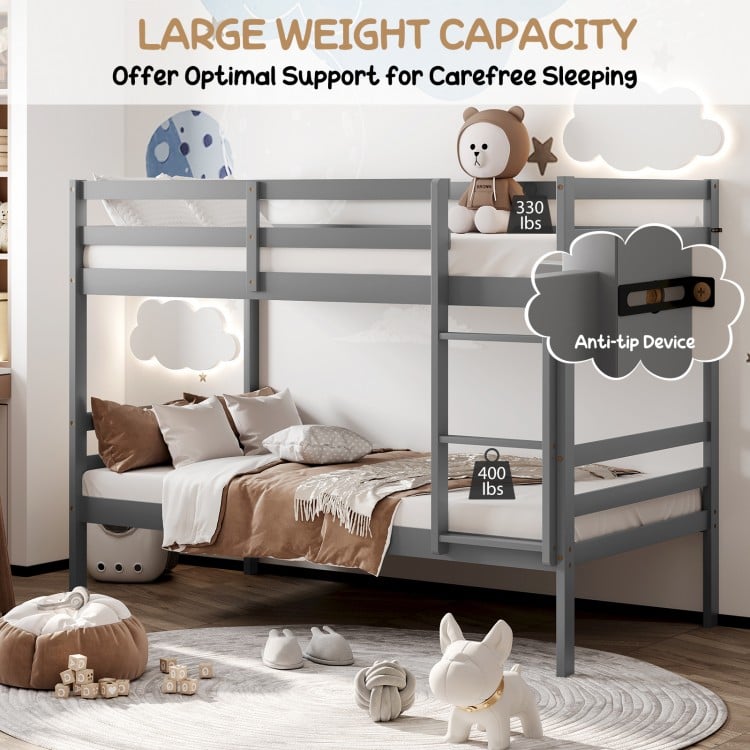 Twin size gray wooden bunk bed with ladder and safety rail, featuring sturdy construction and space-saving design.