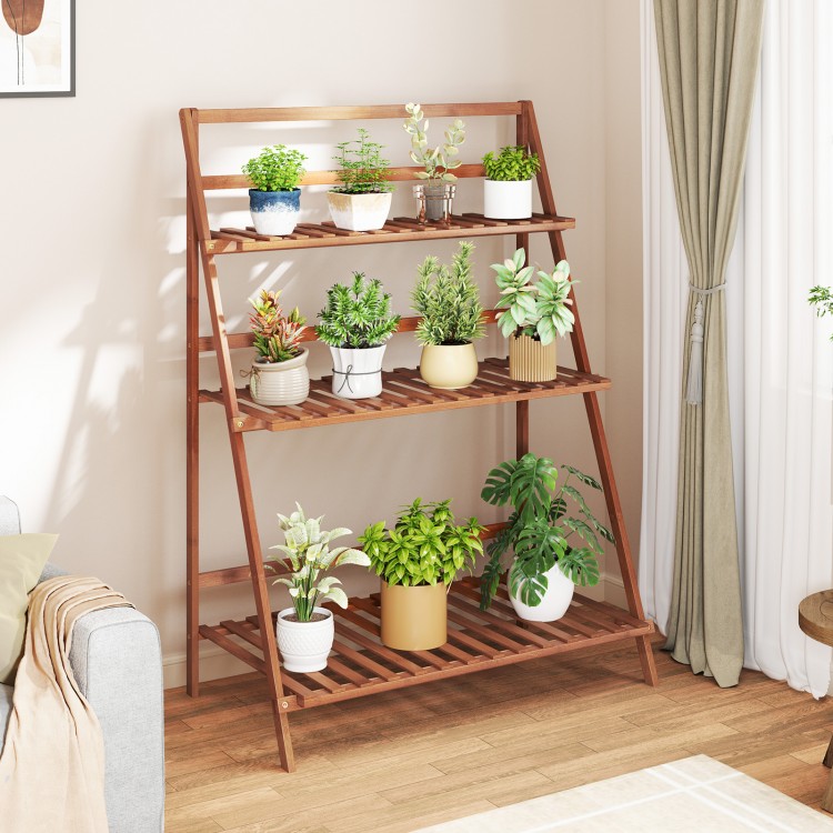 3-tier brown bamboo ladder shelf with plants, ideal for indoor or outdoor use as a display stand or storage rack.