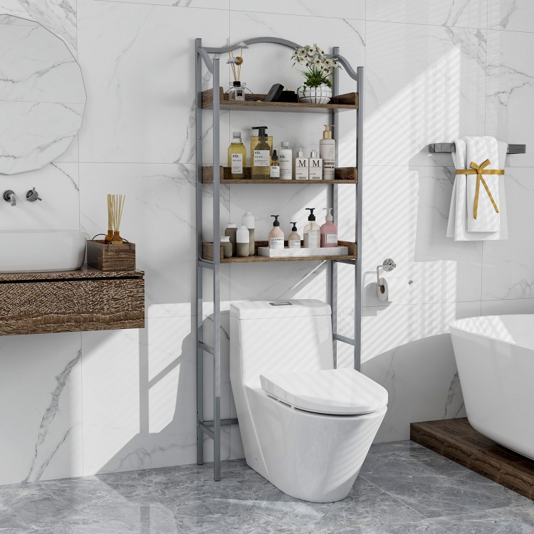 3-tier over-the-toilet storage rack in silver with engineered wood shelves for bathroom essentials and decor.