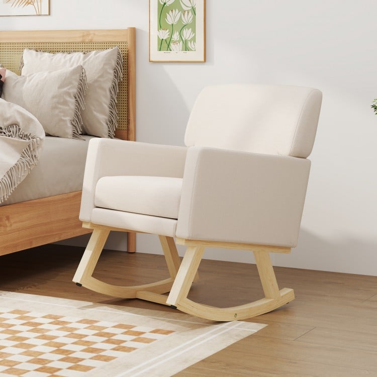 Beige upholstered rocking chair with solid rubber wood base, featuring ergonomic armrests and detachable cushion for.