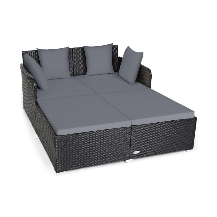 Spacious outdoor rattan daybed featuring a sleek design, gray upholstered cushions, and sturdy aluminum feet for.