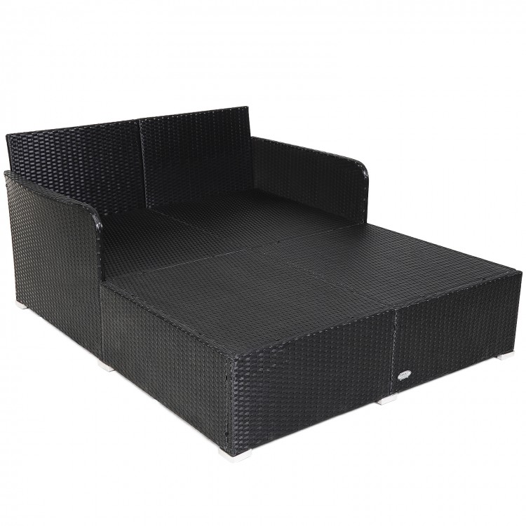 Spacious outdoor rattan daybed in black with upholstered cushions, designed for comfort and support, ideal for.