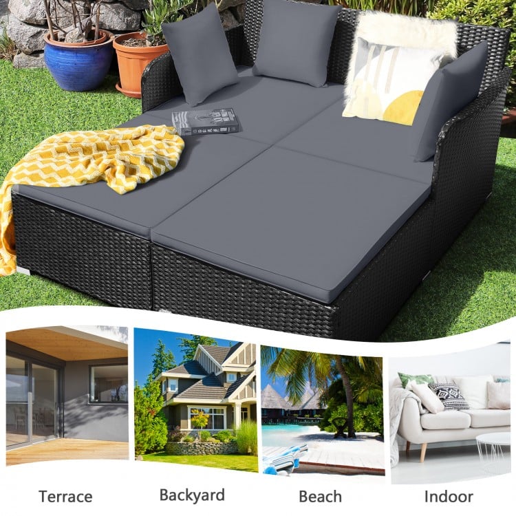 Spacious gray outdoor rattan daybed with upholstered cushions, ideal for terrace, backyard, or indoor relaxation.