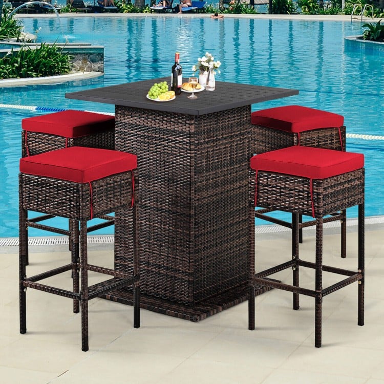 5-piece patio rattan bar set with cushioned red stools and hidden storage, perfect for poolside or backyard gatherings.