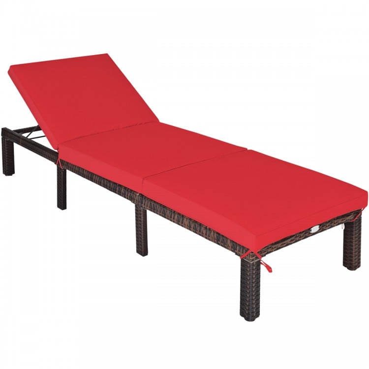Red cushioned outdoor rattan chaise lounge with adjustable backrest, ideal for patio and poolside relaxation.