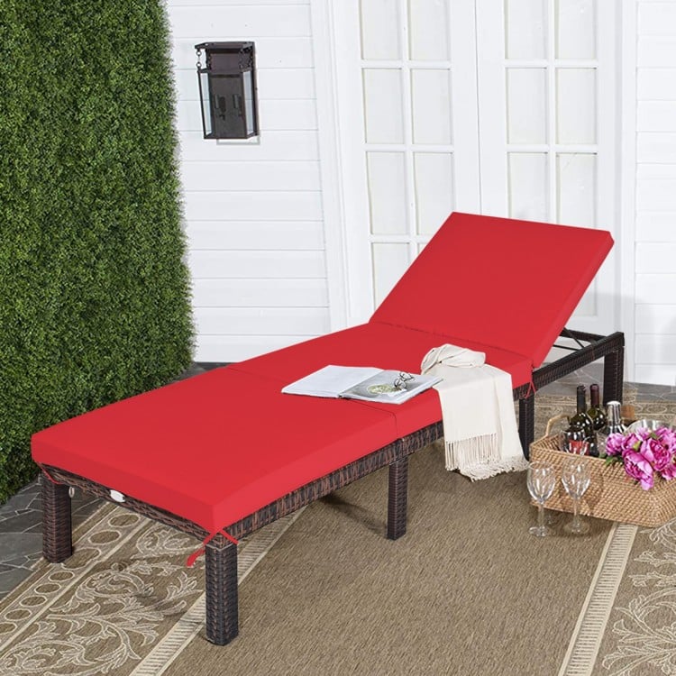 Red outdoor rattan chaise lounge with adjustable backrest and removable cushion, perfect for patio or poolside.