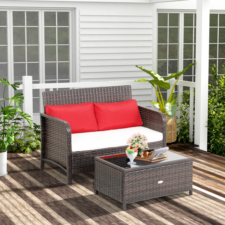 Wicker loveseat set with red cushions and coffee table, featuring hand-woven PE rattan for outdoor use.