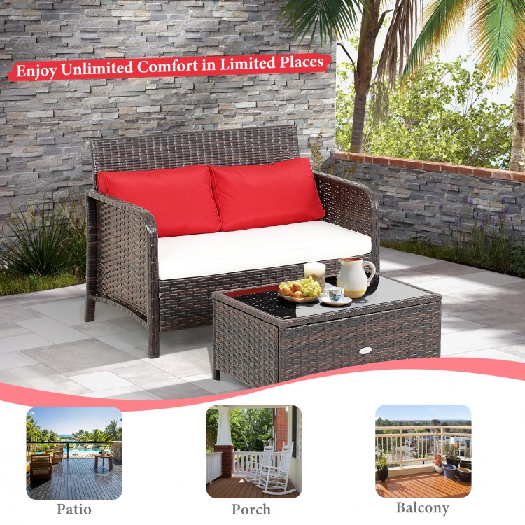 Wicker loveseat set with red cushions and coffee table, featuring ergonomic design for patio, porch, or balcony use.