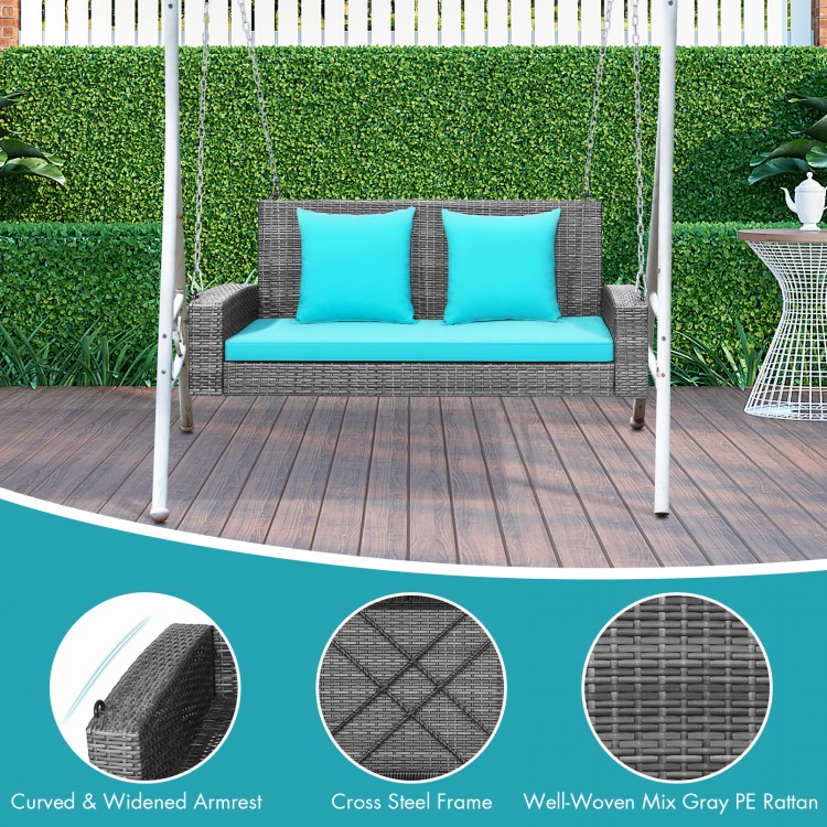 2-person patio PE wicker hanging porch swing bench with turquoise cushions, featuring a sturdy cross steel frame.