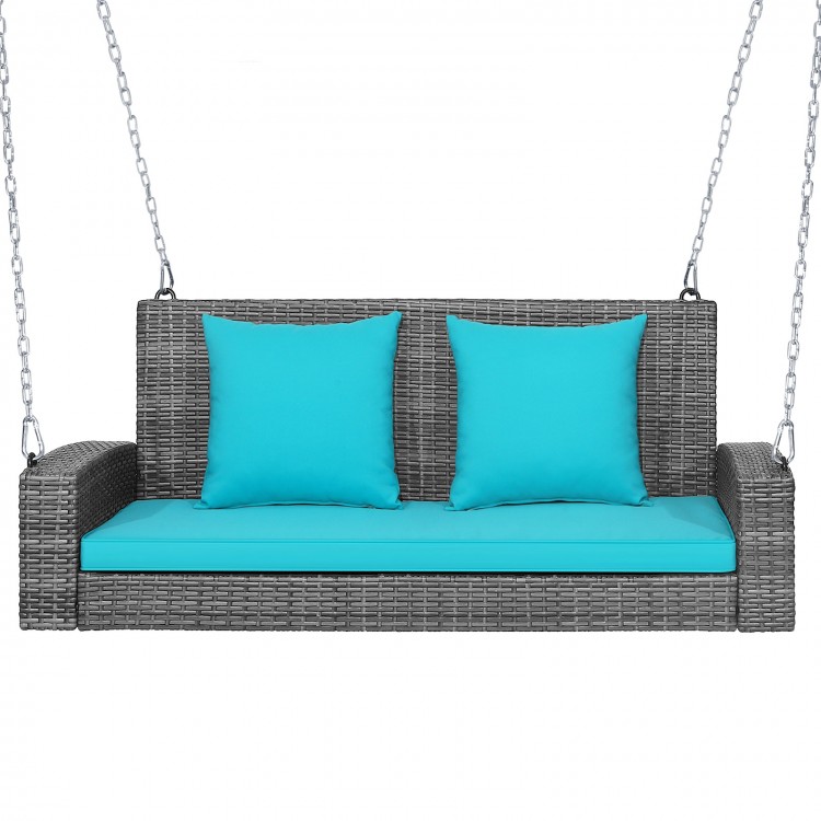 Turquoise cushion 2-person patio PE wicker hanging swing bench with ergonomic armrests and sturdy chains for outdoor.